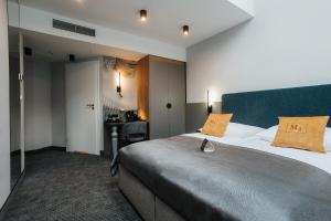 a hotel room with a large bed and a desk at Hotel M4 Boutique in Krakow