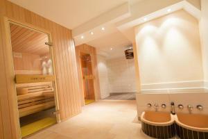 a bathroom with a shower and a sink and a tub at Moin Hotel Cuxhaven in Cuxhaven