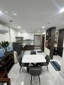 a kitchen with a white table and chairs in it at VHGP-Bs10 in Long Bình +5 photos
