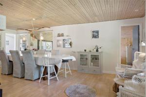 a dining room and living room with a table and chairs at 30394-Ulfborg-Kaprifolievej-8 in Ulfborg +13 photos