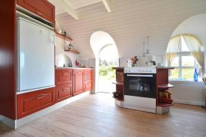 a kitchen with a stove and an oven in a room at 20261-Ulfborg-Vederso-Klitvej-20 in Ulfborg