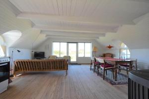 a living room with a table and a couch at 20261-Ulfborg-Vederso-Klitvej-20 in Ulfborg