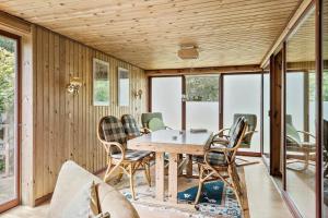 a dining room with a table and chairs at 30065-Ulfborg-Oster-skovvej-63 in Ulfborg
