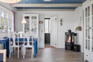 a dining room with a table and a fireplace at 20157-Ulfborg-Revlingvej-8 in Ulfborg +18 photos