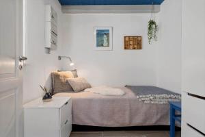 a small bedroom with a bed and a lamp at 20157-Ulfborg-Revlingvej-8 in Ulfborg
