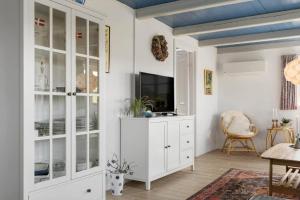 a living room with white cabinets and a tv at 20157-Ulfborg-Revlingvej-8 in Ulfborg