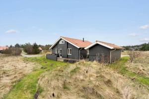 a house sitting on top of a field at 60836-Ulfborg-Fjand-Strand-29 in Ulfborg
