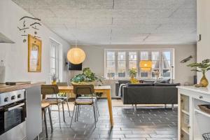 a kitchen and living room with a table and chairs at 70222-Ulfborg-Jagtvejen-8 in Ulfborg