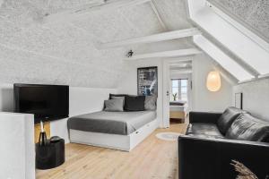 a living room with a bed and a couch at 70222-Ulfborg-Jagtvejen-8 in Ulfborg