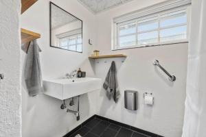 a bathroom with a sink and a mirror at 70222-Ulfborg-Jagtvejen-8 in Ulfborg +31 photos