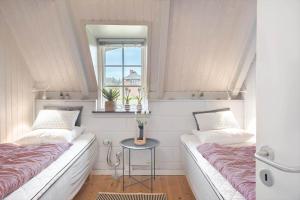 a small room with two beds and a table at 20362-Ulfborg-Sortebaervej-22 in Ulfborg