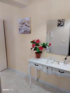 a bathroom with a white sink and a mirror at Casa Doppia G in Oliveri +10 photos