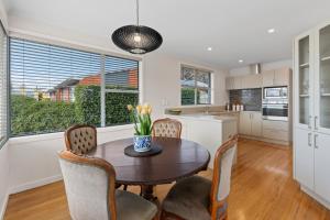 a kitchen and dining room with a table and chairs at Roslyn Sanctuary Highgate Dunedin in Dunedin +10 photos