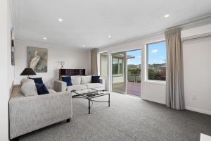 a living room with a couch and a table at Roslyn Sanctuary Highgate Dunedin in Dunedin