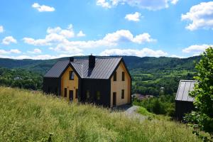 a house on the side of a hill at Osada Dzikie Wino in Budzów