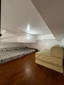 a bedroom with a bed in a room at KMRP Condo Unit in Baguio