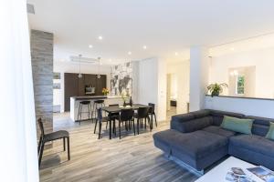 a living room and kitchen with a couch and a table at Residenza The Rock in Nago-Torbole