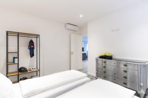 a bedroom with two beds and a dresser at Residenza The Rock in Nago-Torbole +35 photos