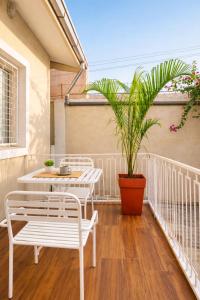 a patio with two chairs and a table and a plant at Milestone Terrace - Premium Apartment near Airport & Super U in Antananarivo +25 photos