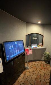 a computer monitor on a desk in a room at ホテルパルシス大人専用 in Shiroishi