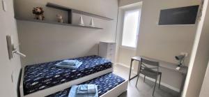 a small bedroom with a bed and a desk at Casa Ilenia Clusane d'Iseo in Clusane sul Lago