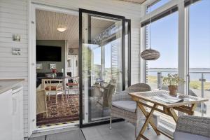 a screened in porch with a table and chairs at SL324-Slagelse-Strandvaenget-29 in Slagelse