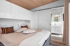 a bedroom with a large bed with white walls at SL324-Slagelse-Strandvaenget-29 in Slagelse