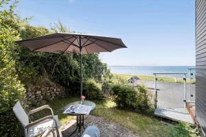a patio with an umbrella and a table and chairs at SL324-Slagelse-Strandvaenget-29 in Slagelse +14 photos