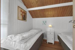 a bedroom with two beds and a wooden ceiling at SL308-Slagelse-Jarlsvej-23 in Slagelse