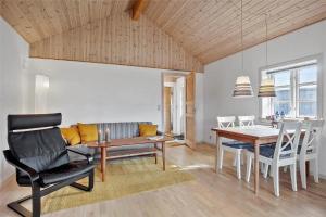 a living room with a table and a dining room at SL283-Slagelse-Havesangervej-2 in Slagelse