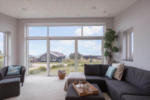 a living room with a couch and a large window at K20039-Kalundborg-Engholmen-1 in Kalundborg