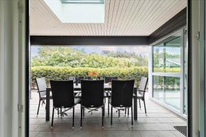 a dining room with a table and chairs on a patio at K20039-Kalundborg-Engholmen-1 in Kalundborg