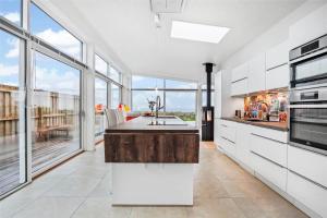 a kitchen with white appliances and large windows at SL287-Slagelse-Strandvaenget-14 in Slagelse +24 photos