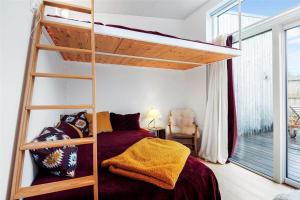 a bedroom with a bunk bed and a large window at SL287-Slagelse-Strandvaenget-14 in Slagelse