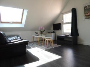 a living room with a couch and a table at Chambre d'hôte Monthorin in Vernie