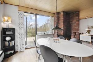 a dining room with a white table and chairs at SL122-Slagelse-Delfivej-6 in Slagelse +16 photos