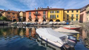 a group of boats in the water near buildings at Namastè in Mandello del Lario