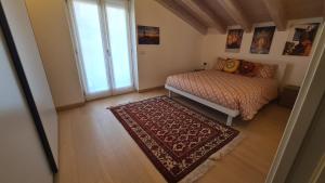 a small bedroom with a bed and a window at Namastè in Mandello del Lario