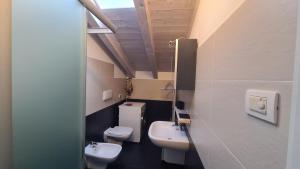 a small bathroom with two toilets and a sink at Namastè in Mandello del Lario +38 photos