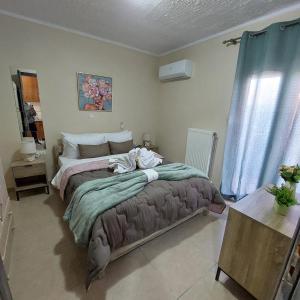 a bedroom with a large bed in a room at The Mastiha Spot 5 in Chios