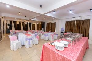 a banquet hall with pink and white tables and chairs at Pietros Square in Butuan