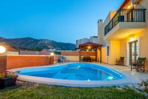 a swimming pool in the backyard of a house at Hersonissos Villas in Hersonissos
