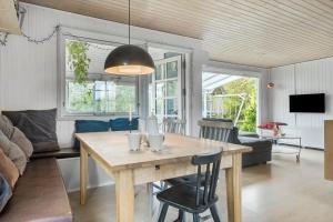 a living room with a table and a couch at SL325-Slagelse-Ringduevej-6 in Slagelse