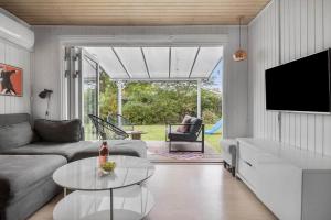 a living room with a couch and a table at SL325-Slagelse-Ringduevej-6 in Slagelse