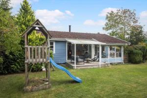 a house with a playground with a slide at SL325-Slagelse-Ringduevej-6 in Slagelse