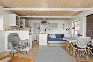 a kitchen and living room with a table and chairs at SL216-Slagelse-Bildsovej-117 in Slagelse