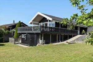 a large house with a deck and a yard at SL216-Slagelse-Bildsovej-117 in Slagelse +29 photos