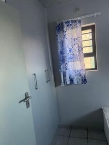 a bathroom with a window and a shower curtain at Private Room in a 2-Bed Apartment Shared in Farmall