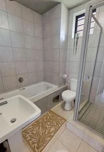 a bathroom with a tub and a toilet and a sink at Private Room in a 2-Bed Apartment Shared in Farmall