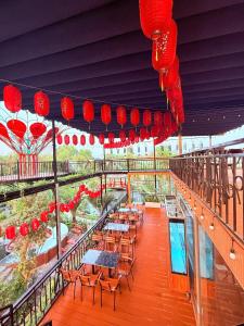 a balcony with tables and chairs and red lanterns at Uniton Zen Garden in Ấp Bến Cầu